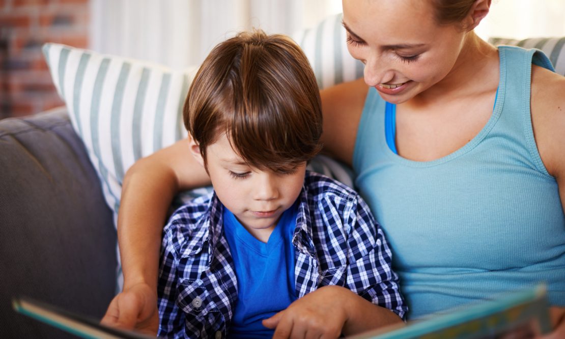 Cropped shot of a young mother and her son reading together